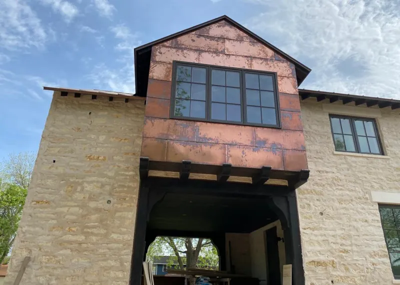 Copper metal panel facade on a stone building for Roof Repair in Scotts Valley